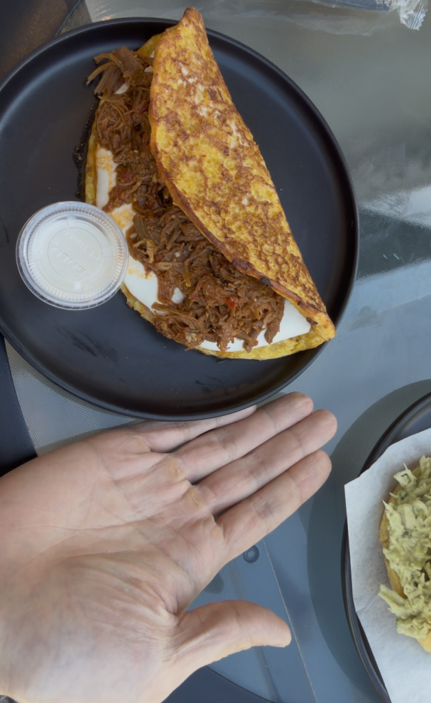 Santo Cafe - hand size comparison of cachapa mechada